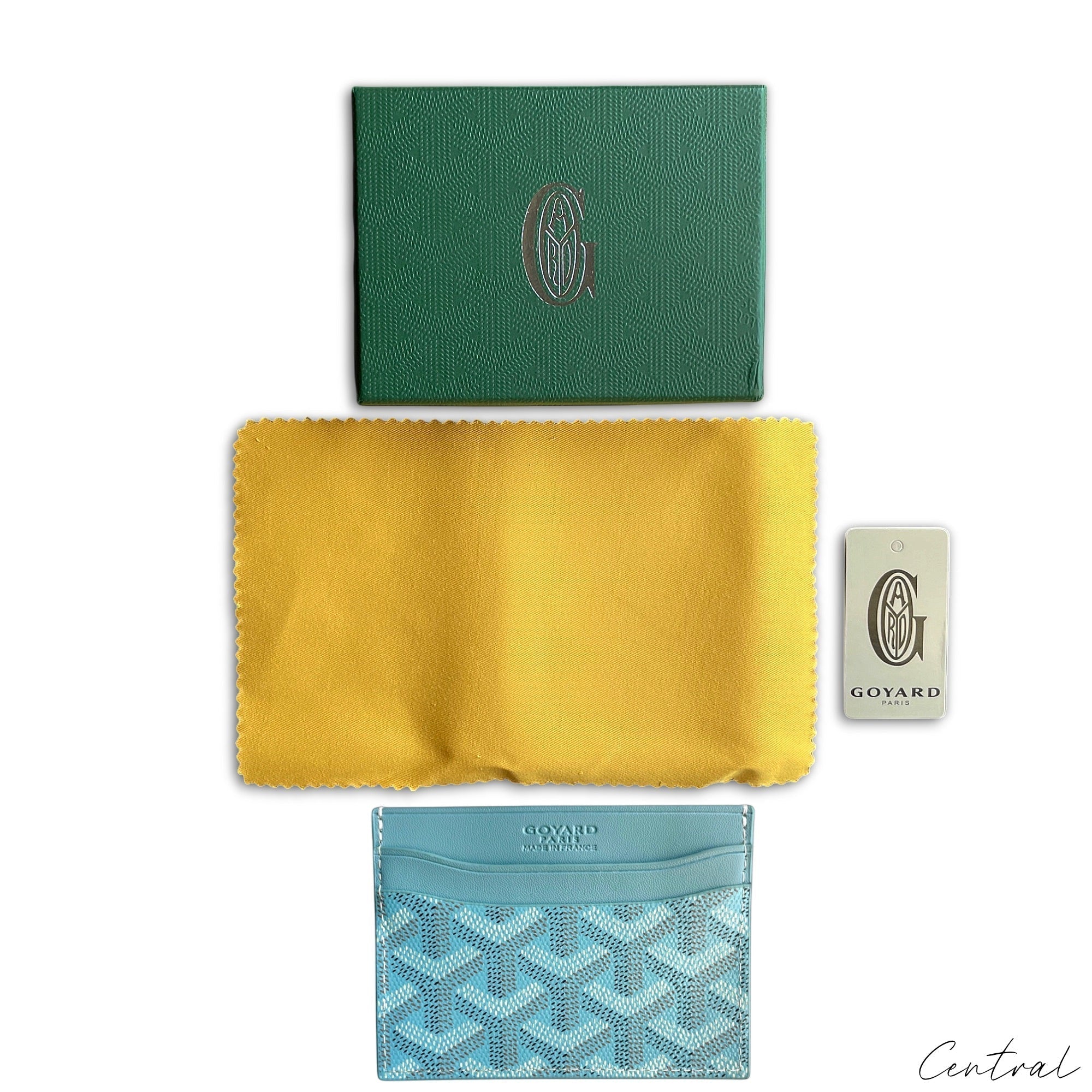Baby blue Goyard card holder with signature pattern, featuring a sleek design and compact size for easy carrying.