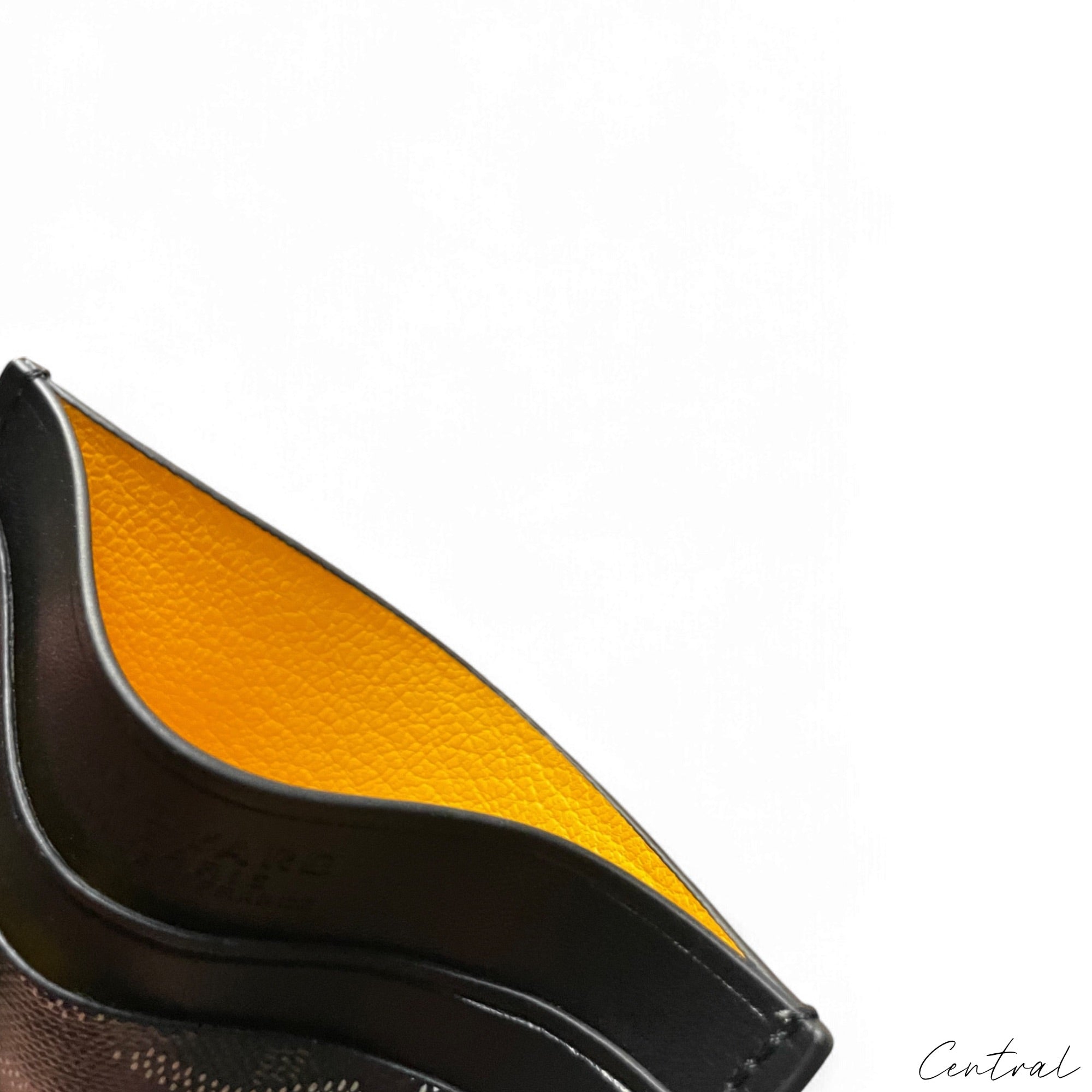 Black Goyard card holder by Central ae, featuring a sleek design and the iconic Goyard pattern.