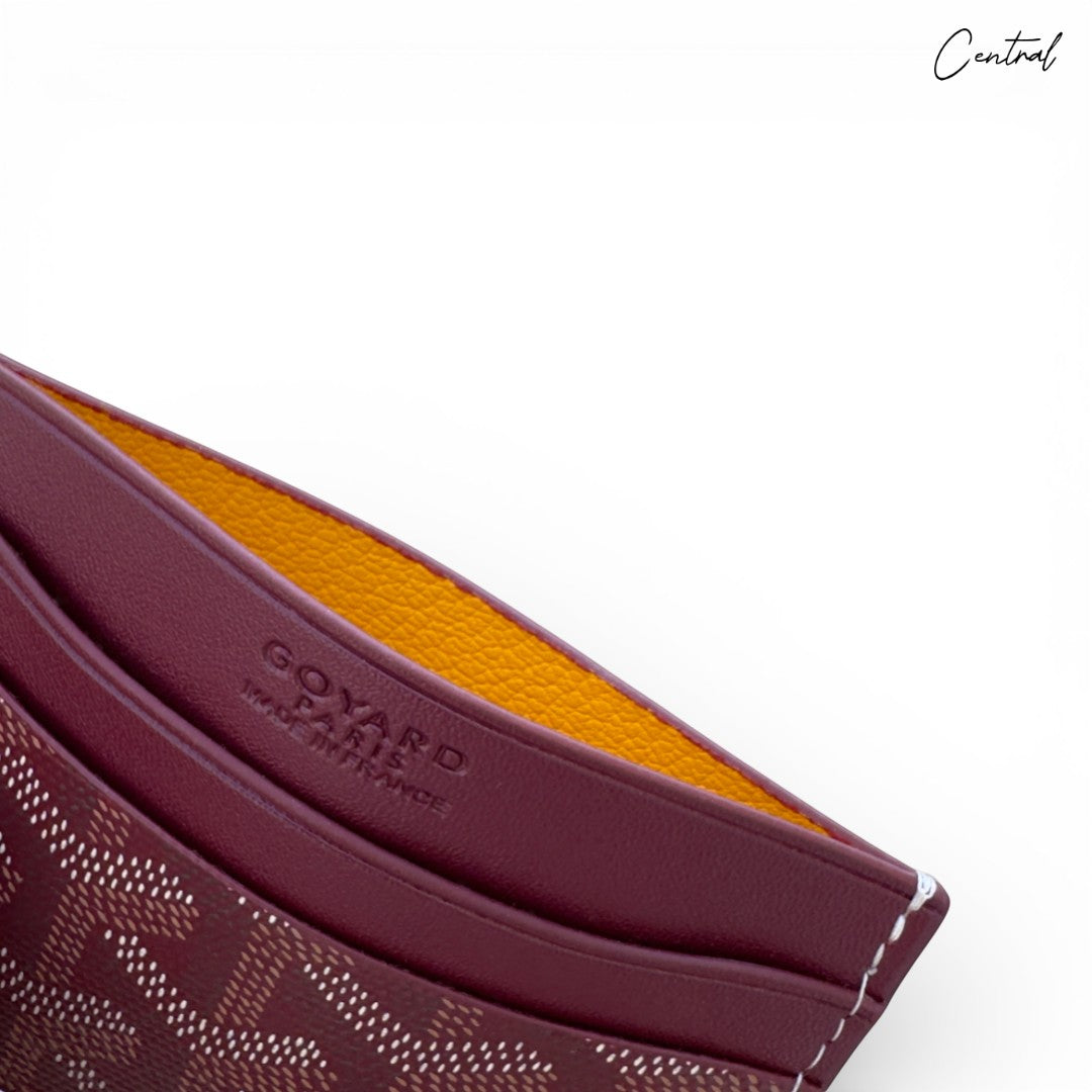 Burgundy Goyard card holder with signature pattern and sleek design, perfect for storing cards and essentials.