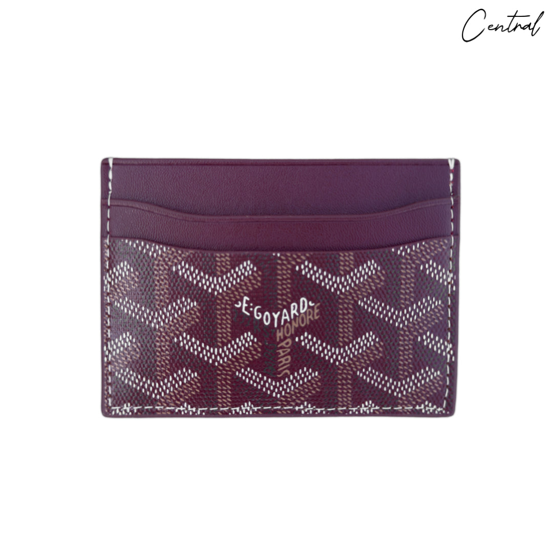 Burgundy Goyard card holder featuring signature pattern and sleek design, ideal for carrying essential cards.