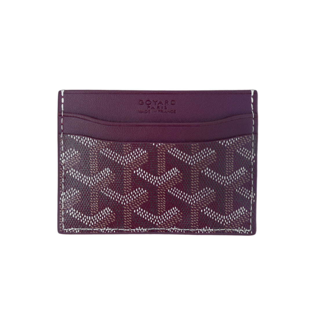 Burgundy Goyard card holder featuring iconic pattern and sleek design, ideal for carrying cards and essentials.