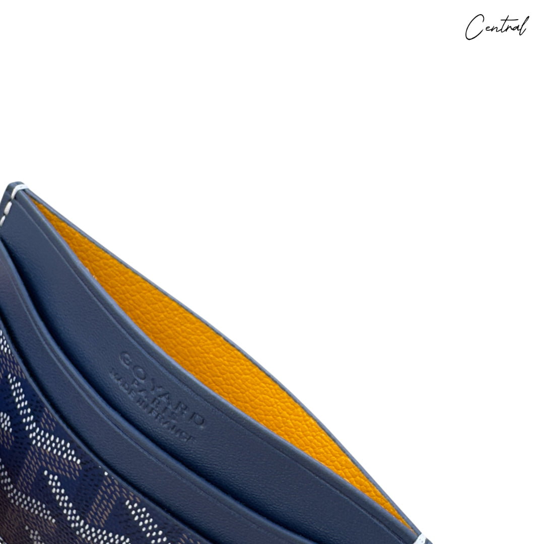 Royal blue Goyard card holder showcasing classic design and signature patterns on a sleek leather surface.