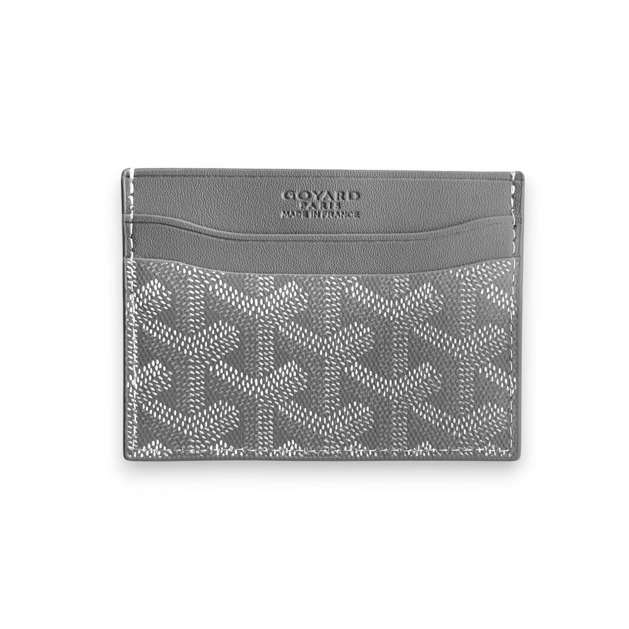Gray Goyard card holder featuring the brand's signature pattern and sleek design, displayed on a neutral background.