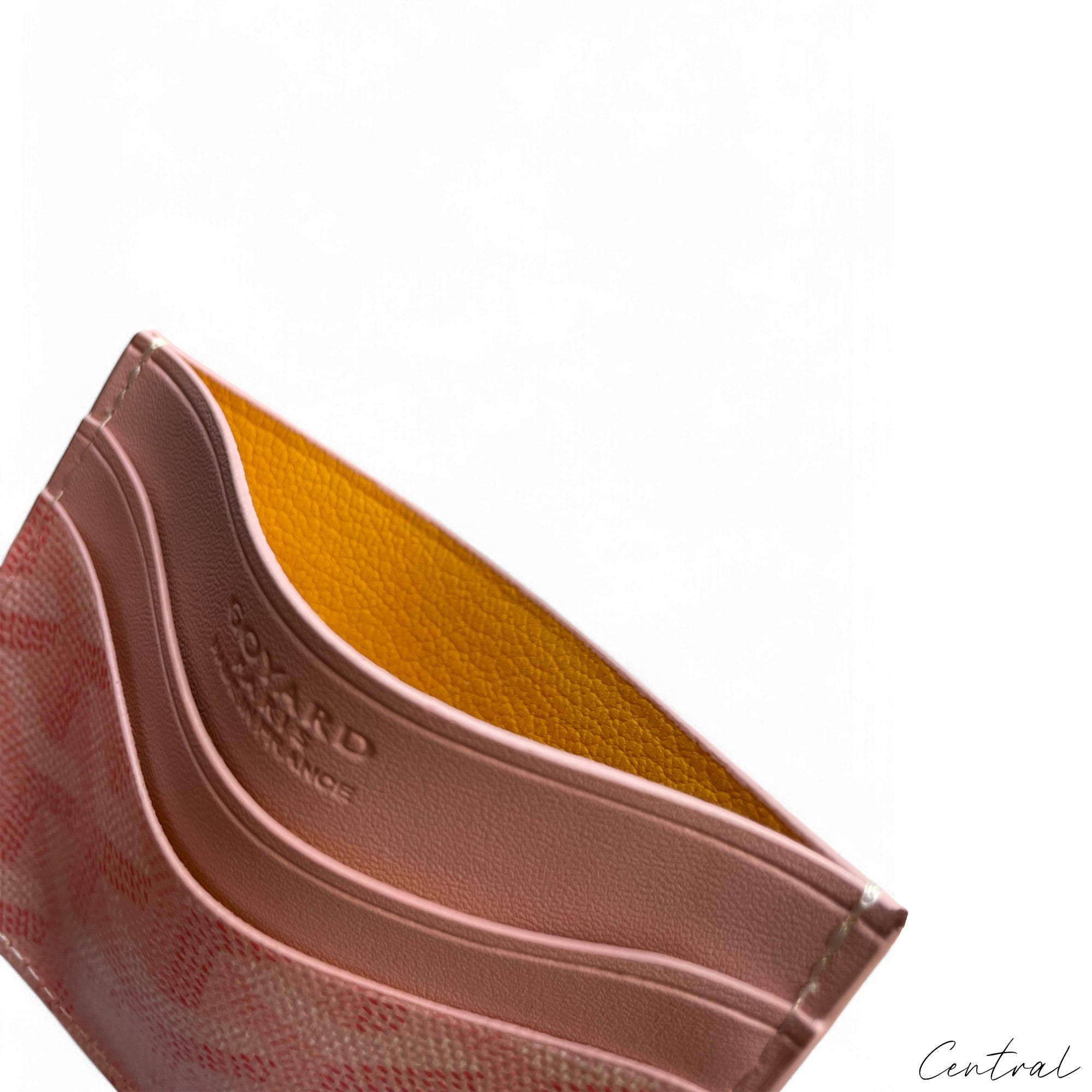 Pink Goyard card holder featuring the brand's signature pattern and sleek design, ideal for storing cards and cash.