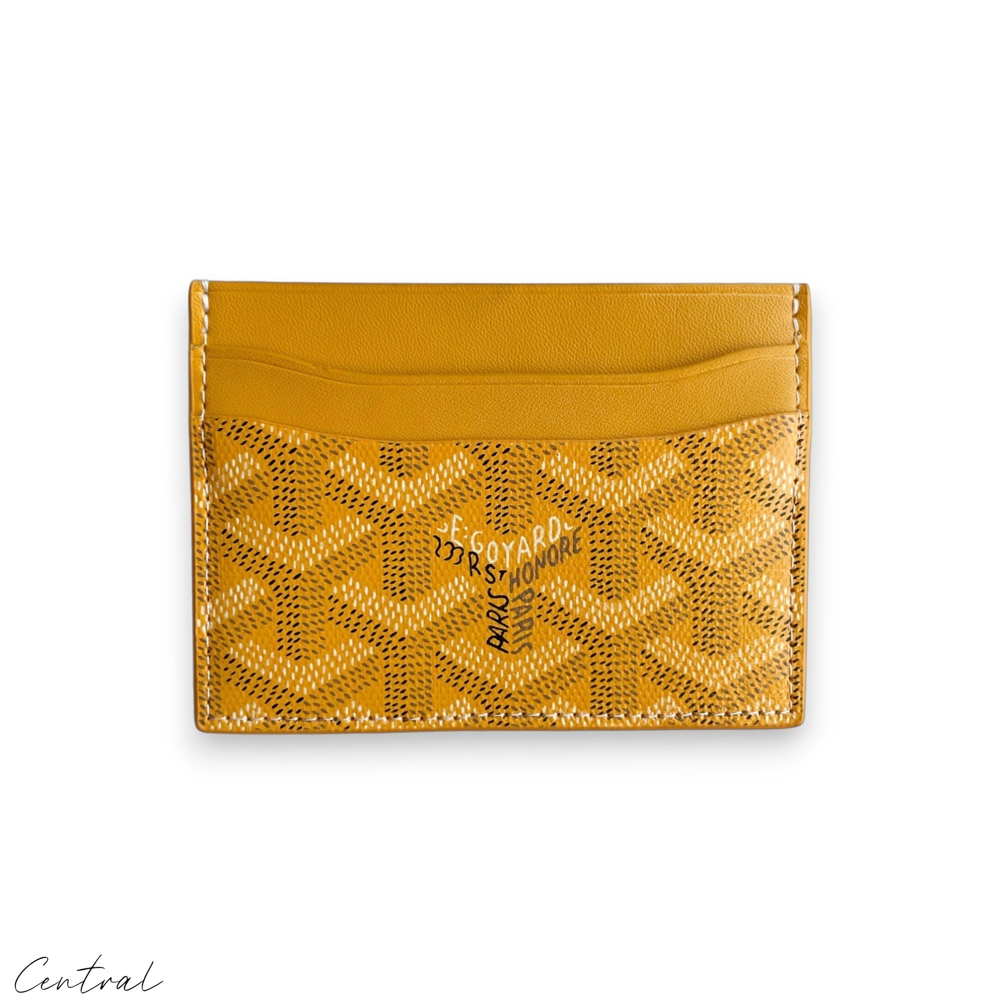 Yellow Goyard card holder featuring a sleek design and iconic brand pattern, displayed on a neutral background.