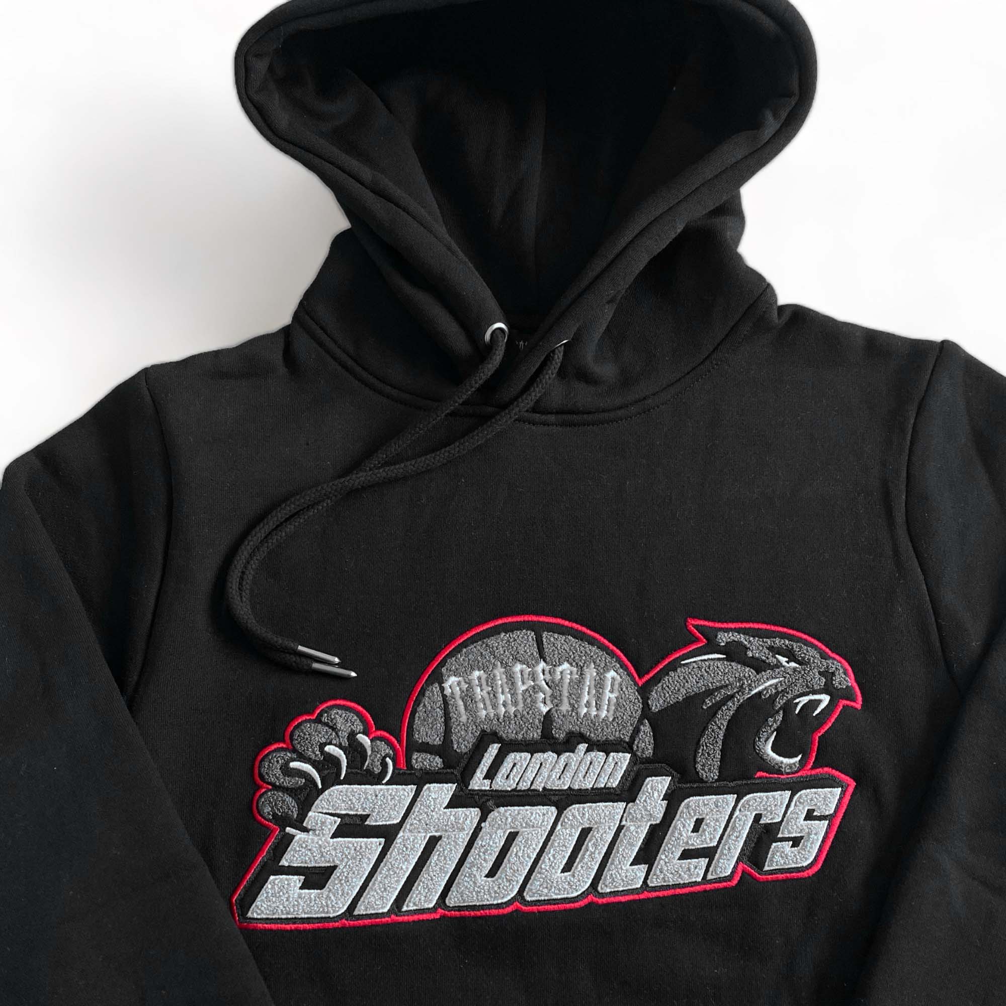 Trapstar Shooters black-red tracksuit featuring a stylish hoodie and matching pants set.