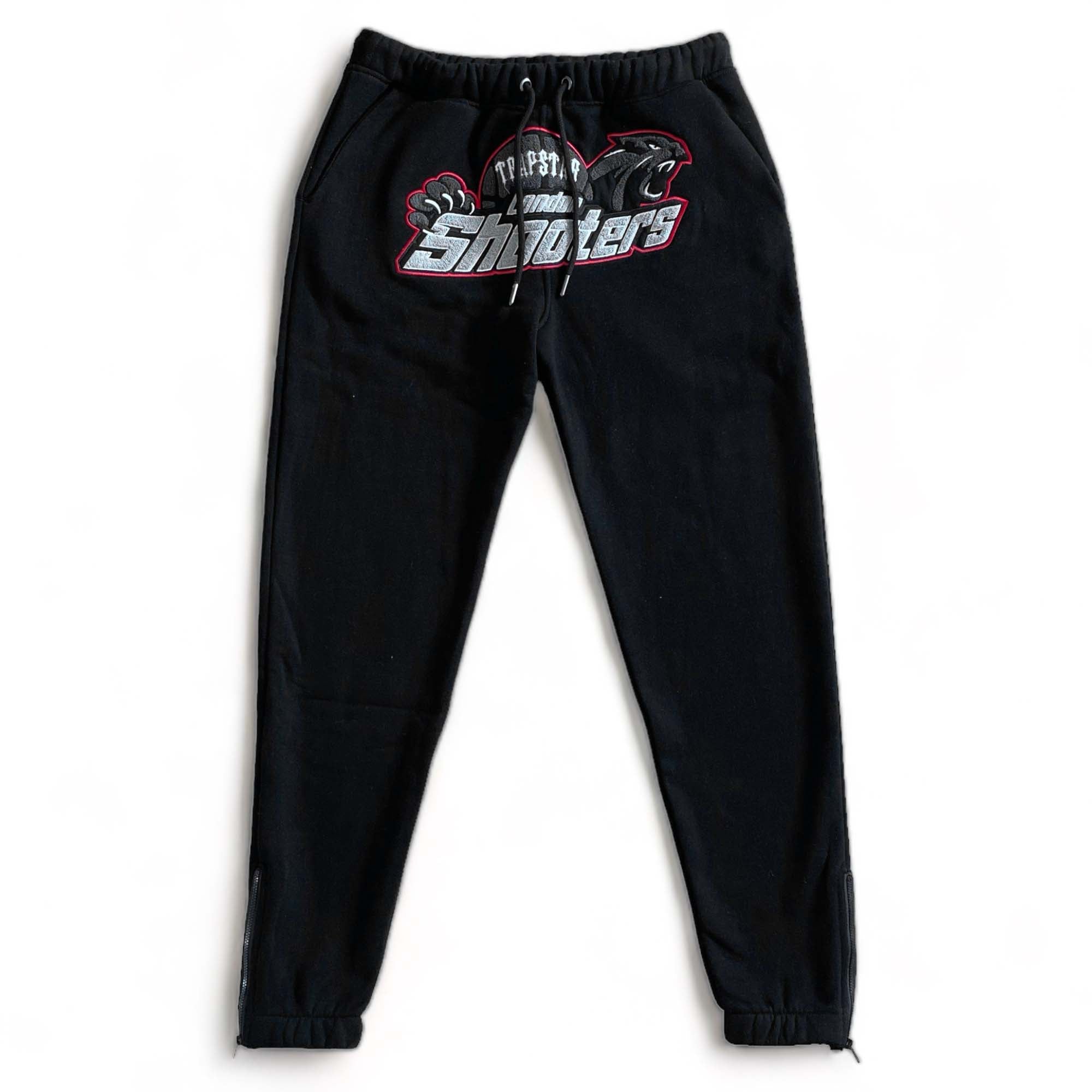 Trapstar Shooters tracksuit in black and red featuring a hoodie and matching pants set displayed on a neutral background.