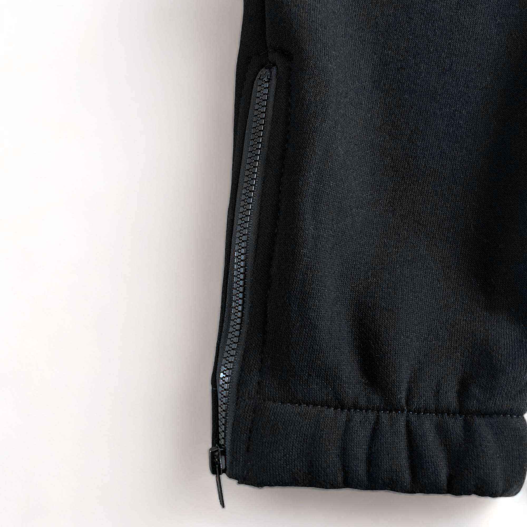 Trapstar Shooters black and red tracksuit featuring a hoodie and pants set, displayed on a neutral background.