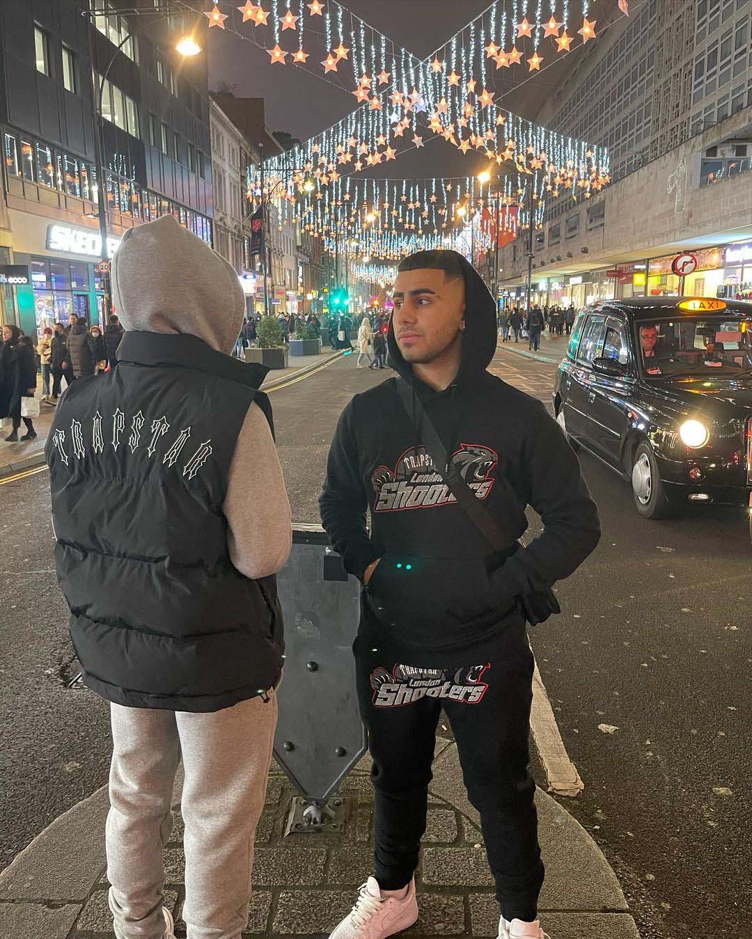 Trapstar Shooters tracksuit in black and red featuring a hoodie and pants set, displayed on a neutral background.