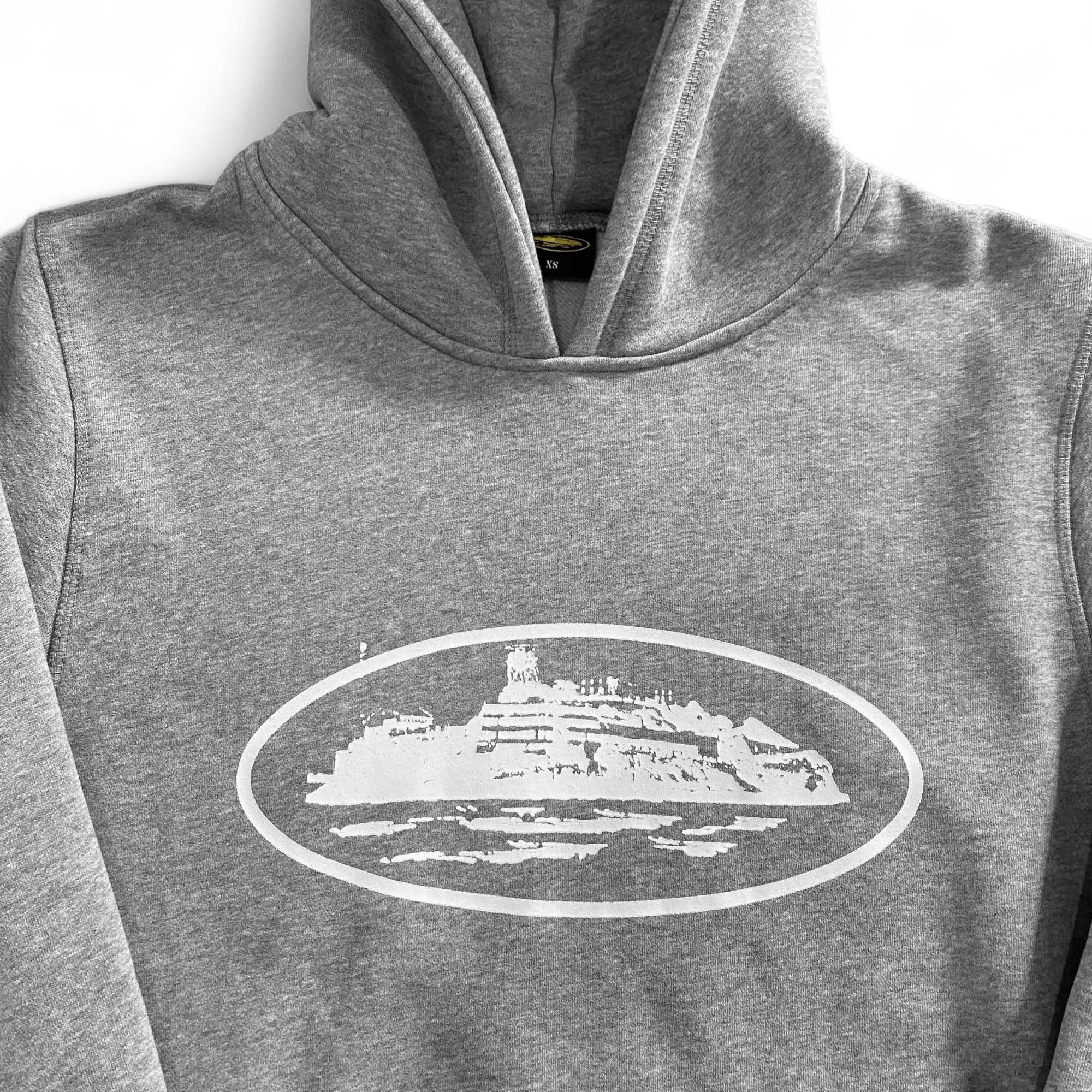 Grey Corteiz Alcatraz hoodie featuring a relaxed fit and bold branding on the front, perfect for casual wear.