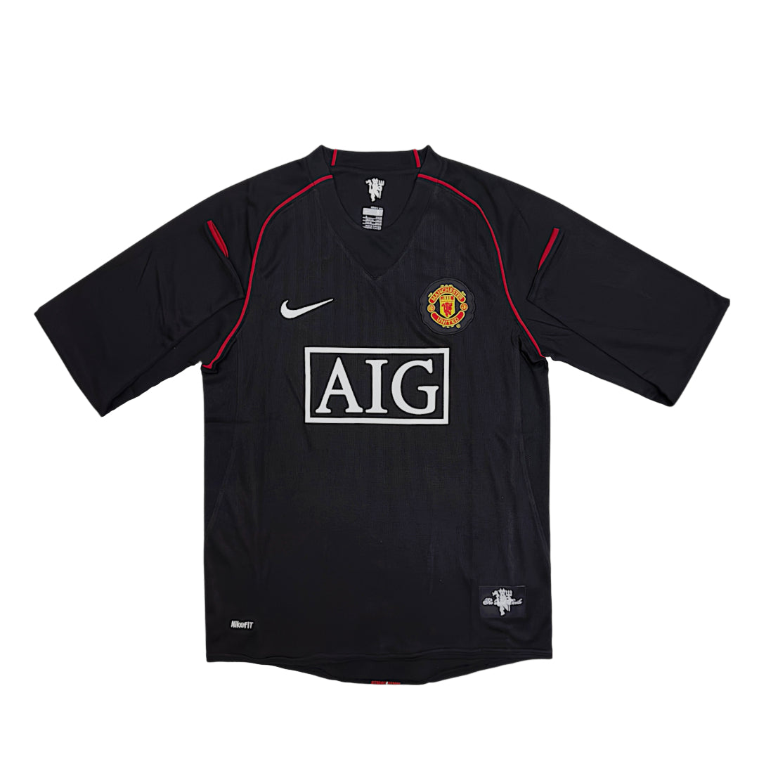 2007-08 Manchester United long-sleeve away shirt by Central Ae in vibrant away colors with team logo.