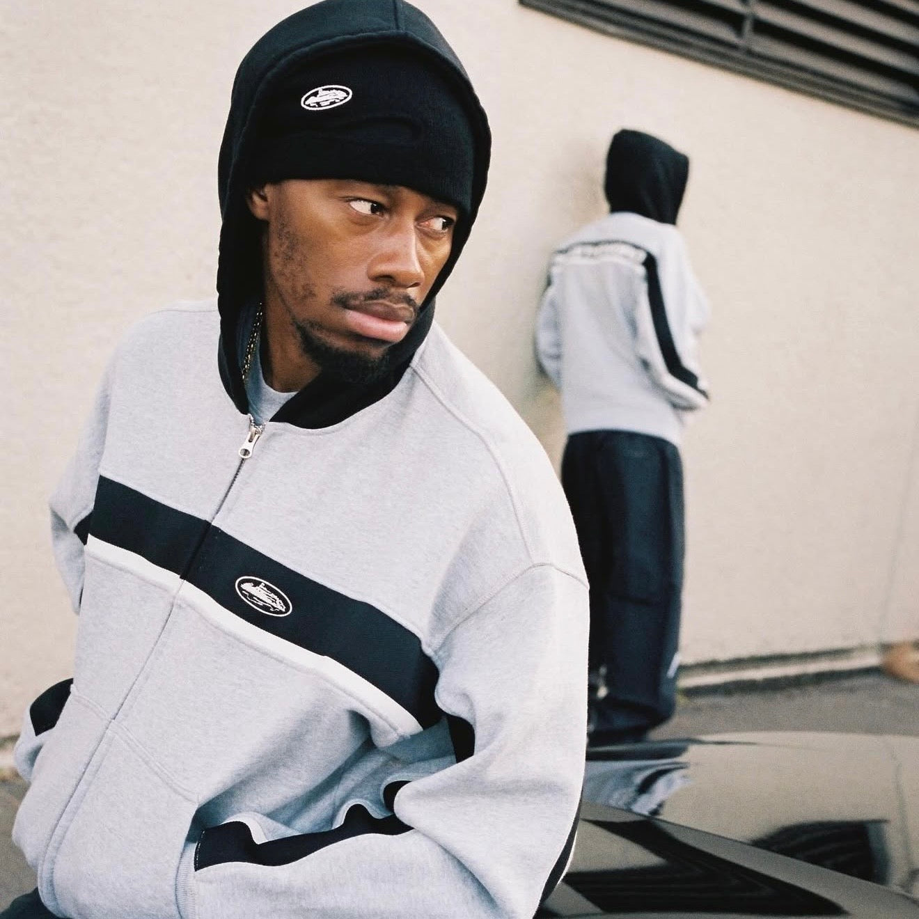 Corteiz Ribbed Sporteiz Zip Hoodie in grey with a front zipper and ribbed texture, displayed on a hanger.