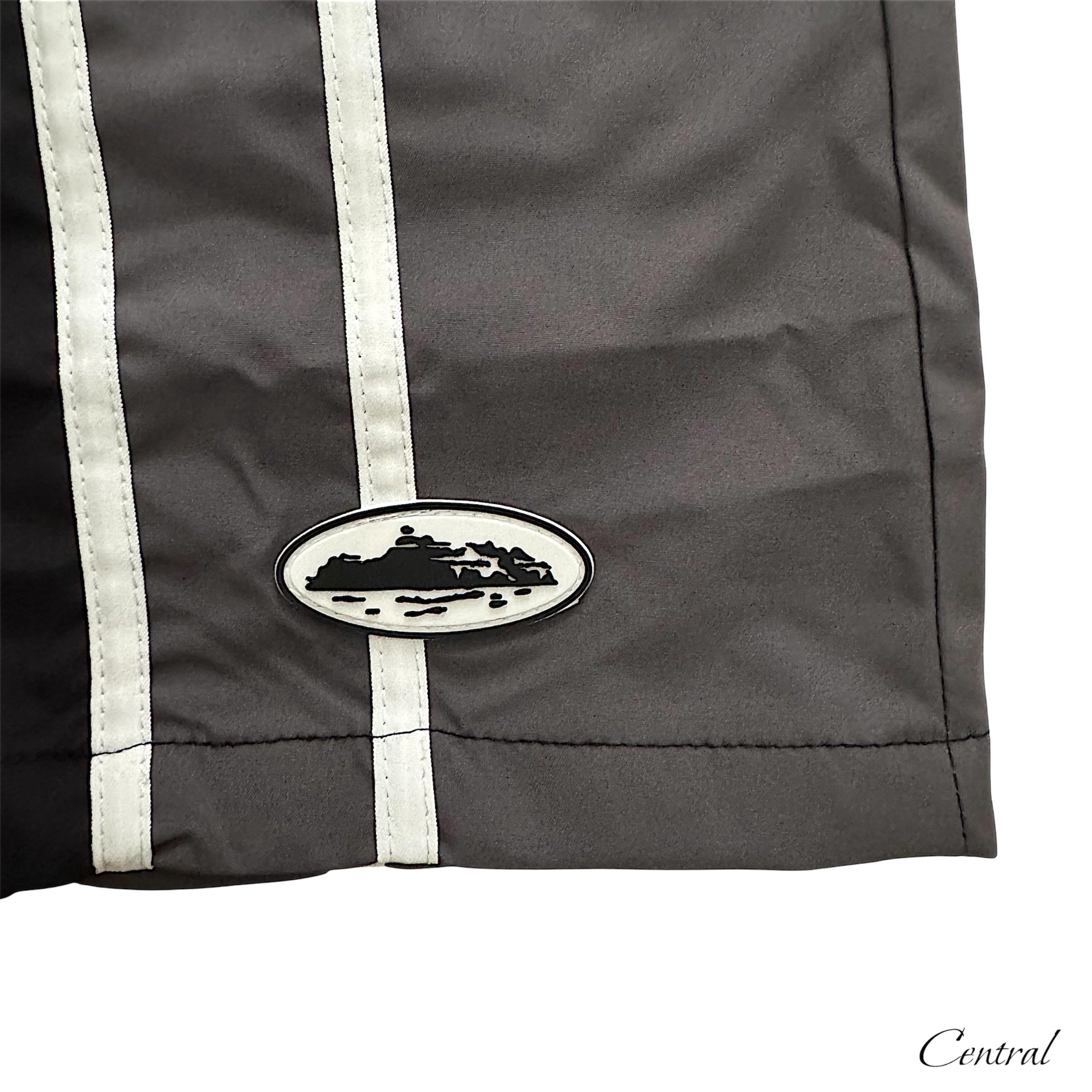 Black Corteiz shorts from Central.ae displayed on a flat surface, showcasing the fabric and design details.