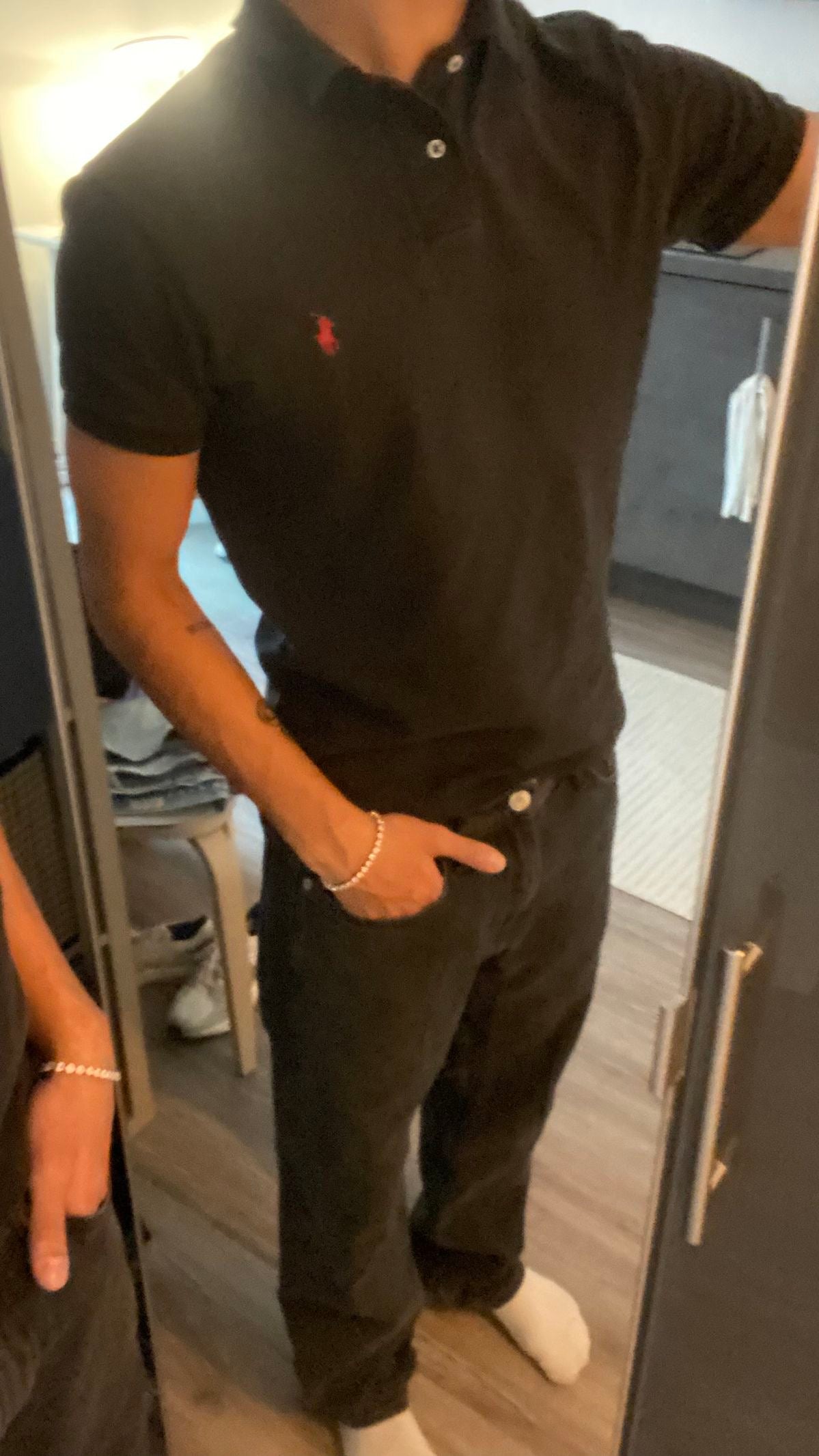 Ralph Lauren Polo shirt in black, featuring the iconic logo and classic design, displayed on a plain background.