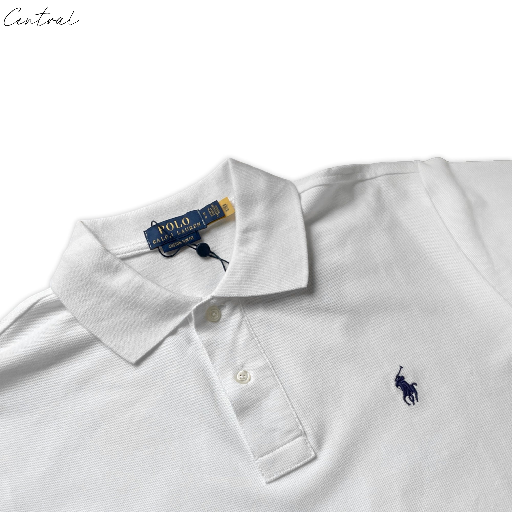 White Ralph Lauren polo shirt displayed on a hanger, featuring the iconic logo and classic collar design.