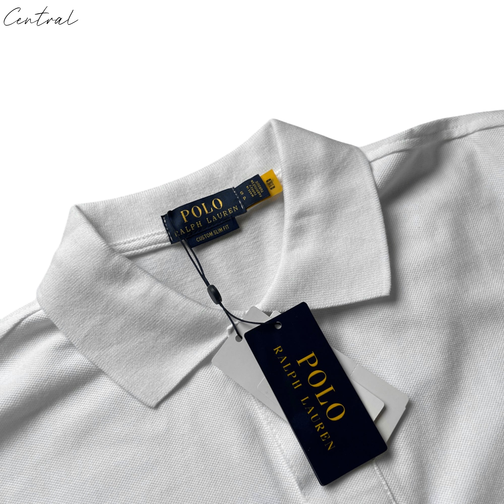 White Ralph Lauren polo shirt displayed on a hanger, featuring a classic collar and embroidered logo.