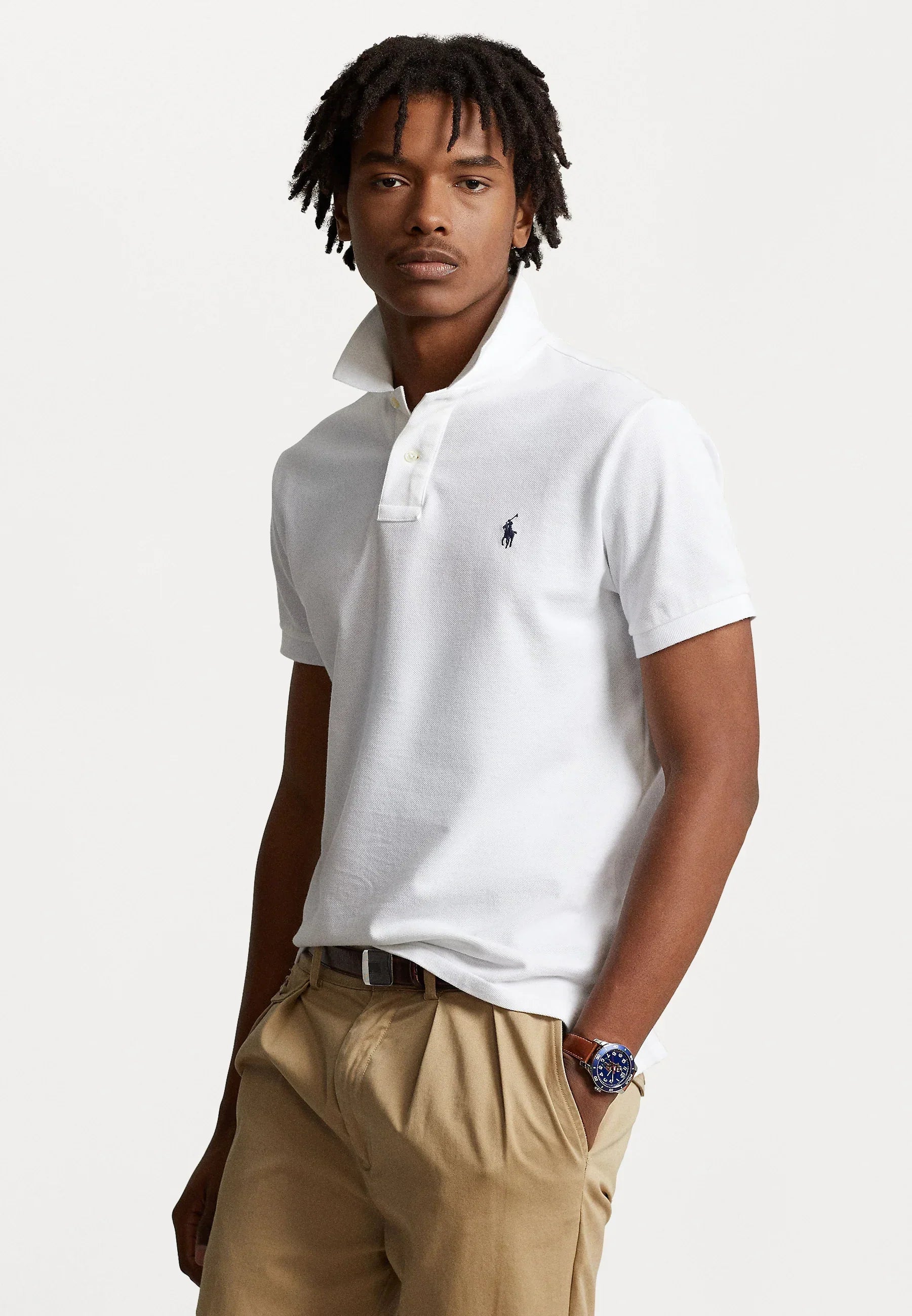 Men's Ralph Lauren white polo shirt displayed on a hanger, featuring the signature logo and classic collar design.