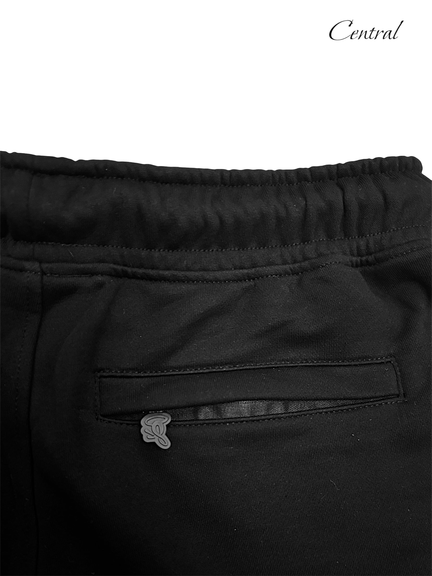 Black and rose gold Syna T-shirt and shorts set displayed flat, showcasing fabric texture and stylish design.