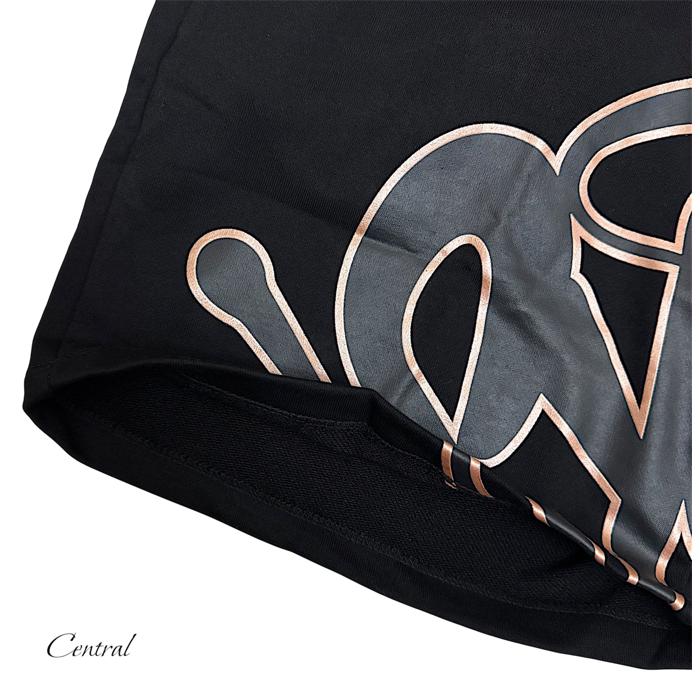 Black and rose gold Syna t-shirt and shorts set displayed on a flat surface, showcasing fabric texture and design.