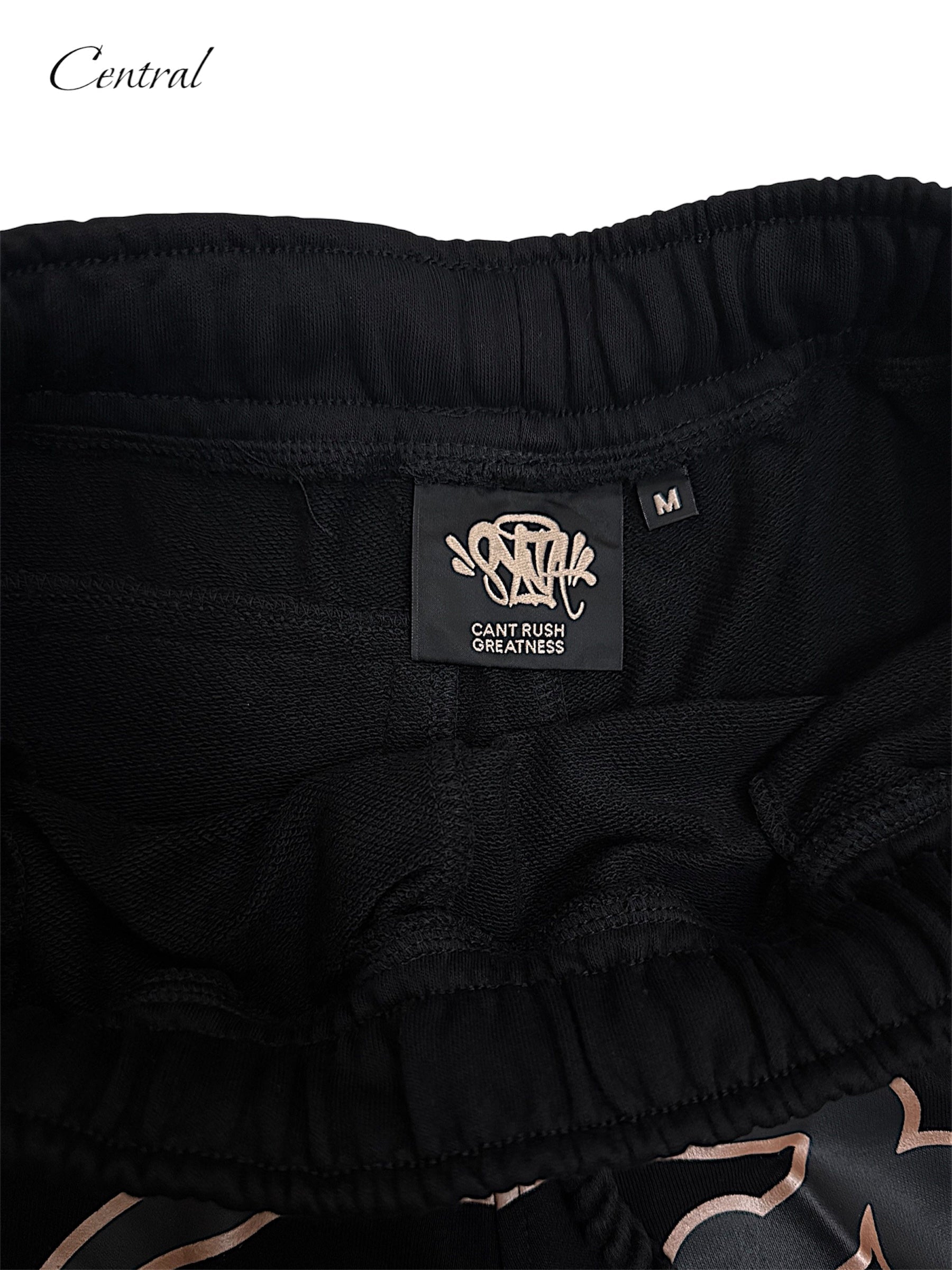 Black and rose gold Syna T-shirt and shorts set displayed on a flat surface. Casual style by Central.ae.