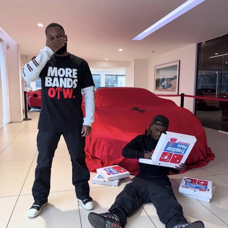 Black Trapstar x More Bands OTW Tee featuring a bold graphic design and relaxed fit, displayed on a neutral background.