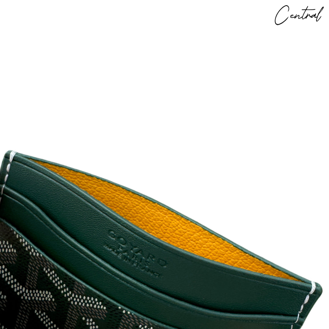 Green Goyard card holder wallet from Central ae, showcasing its sleek design and signature pattern.