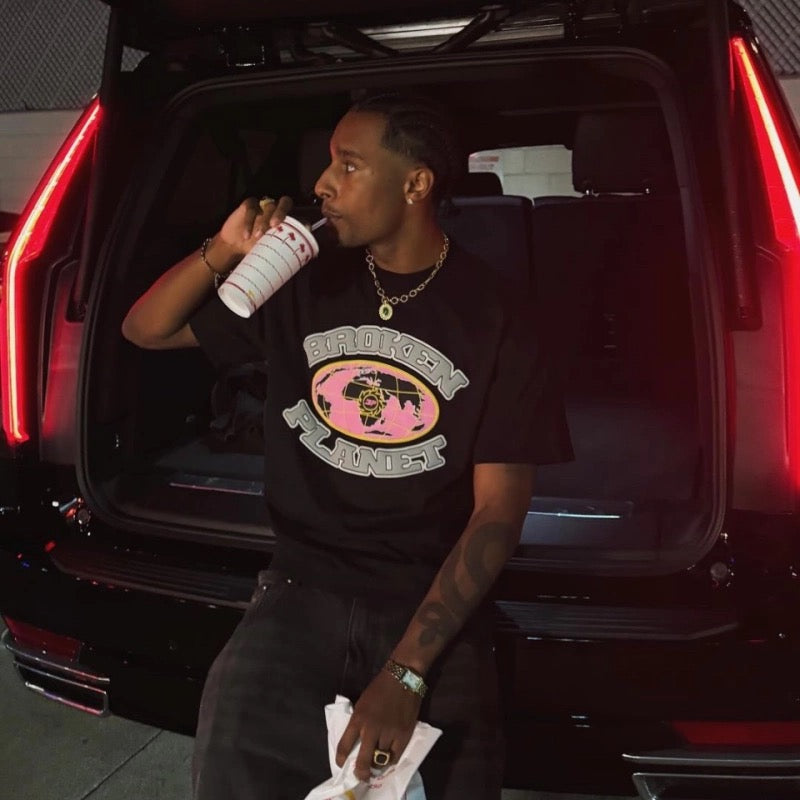 Broken Planet Gird T-Shirt featuring a graphic design, displayed on a neutral background.