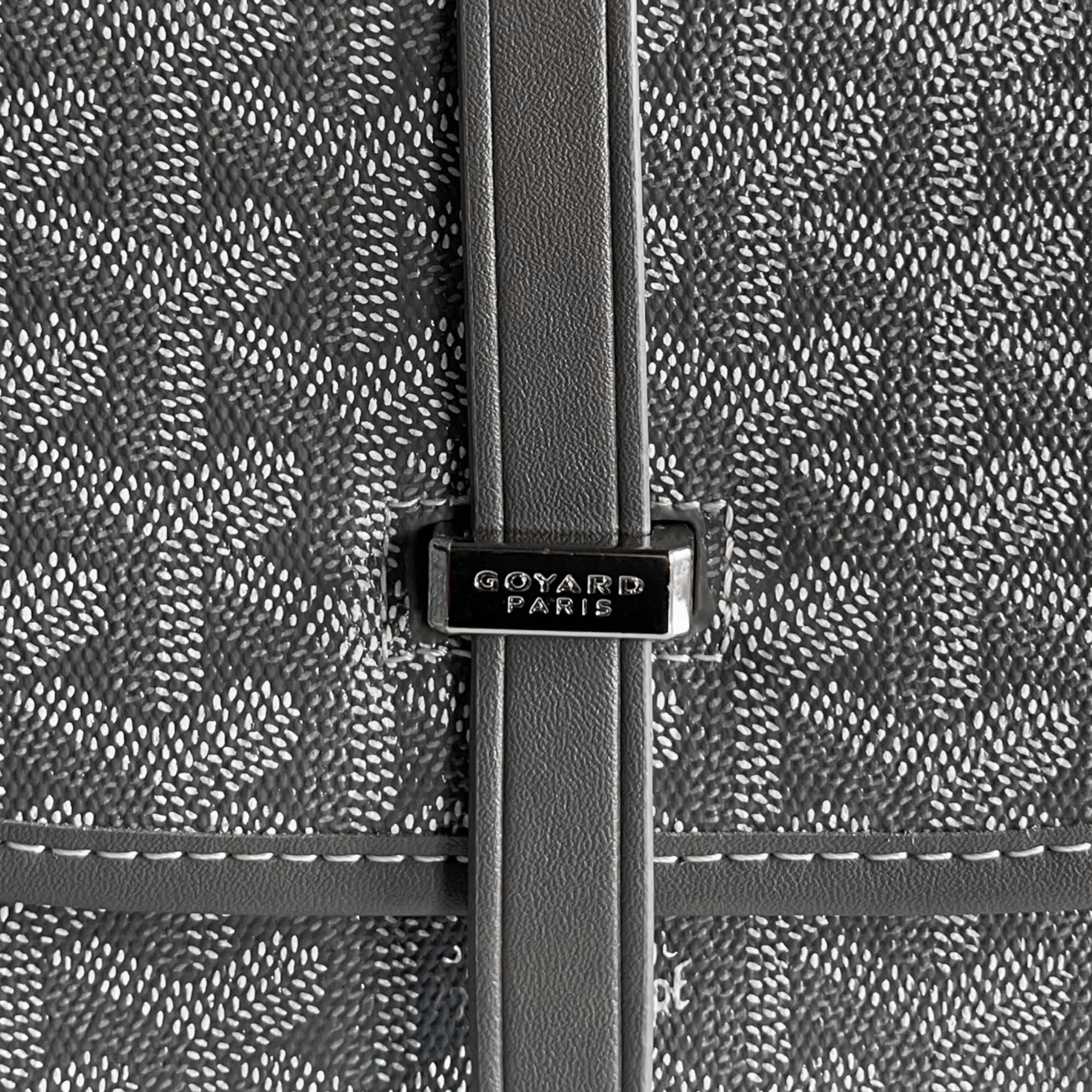 Grey Goyard bag by Central ae, showcasing its signature pattern and structured design.