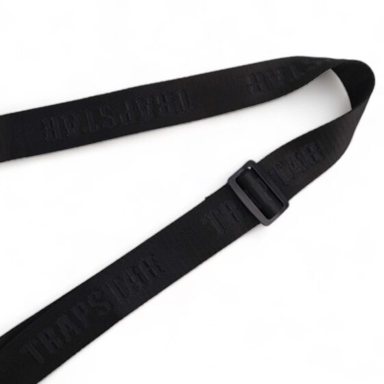 Trapstar black and white Irongate T cross-body bag with adjustable strap and sleek design displayed on a flat surface.