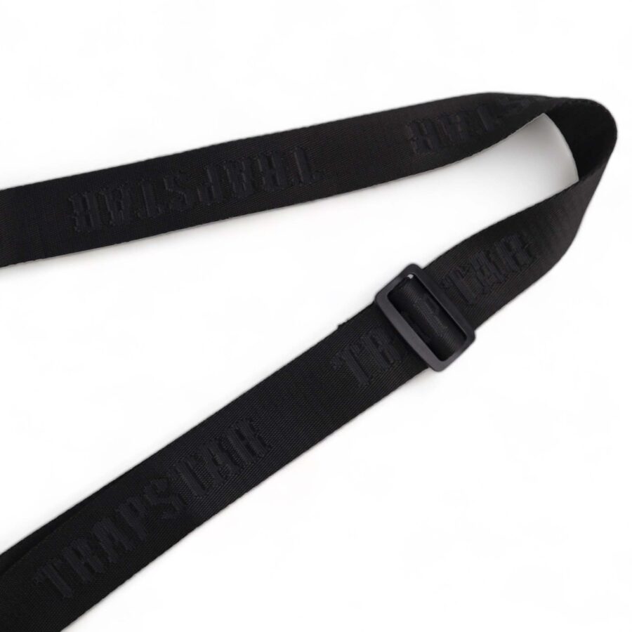 Trapstar black and white Irongate T cross-body bag with adjustable strap and sleek design displayed on a flat surface.