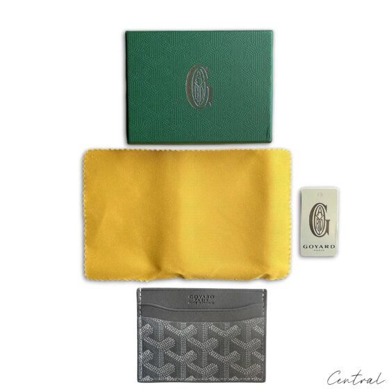 Gray Goyard card holder featuring signature pattern and sleek design, ideal for carrying credit cards and IDs.