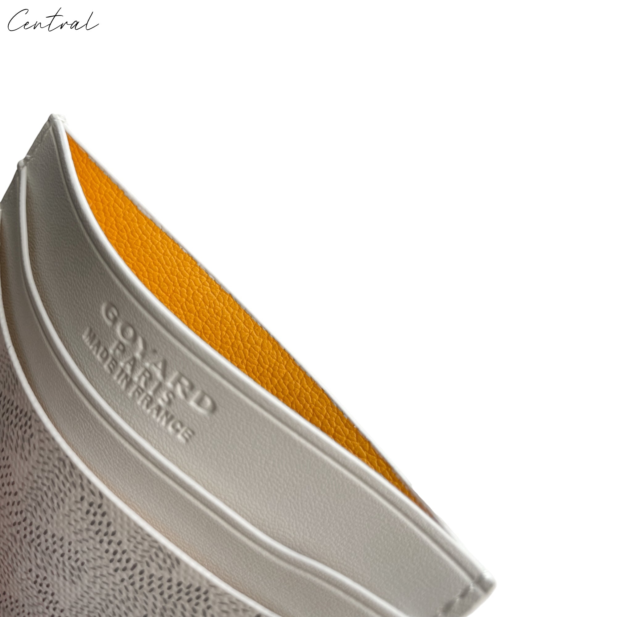 White Goyard card holder featuring a sleek design and iconic logo, showcasing craftsmanship and elegance.