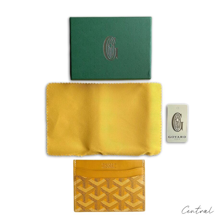 Yellow Goyard card holder featuring signature pattern and sleek design, ideal for carrying essential cards.