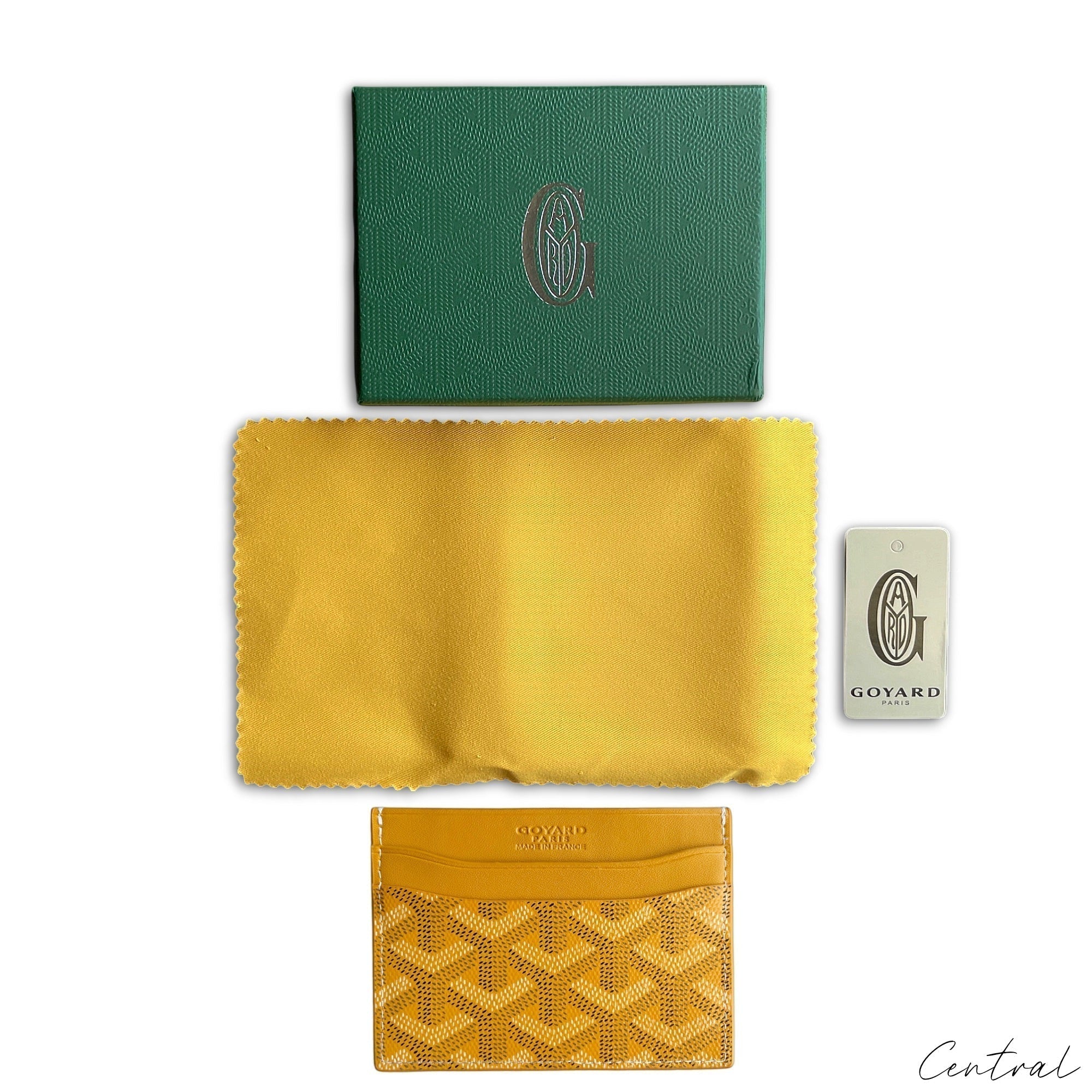 Yellow Goyard card holder featuring signature pattern and sleek design, ideal for carrying essential cards.