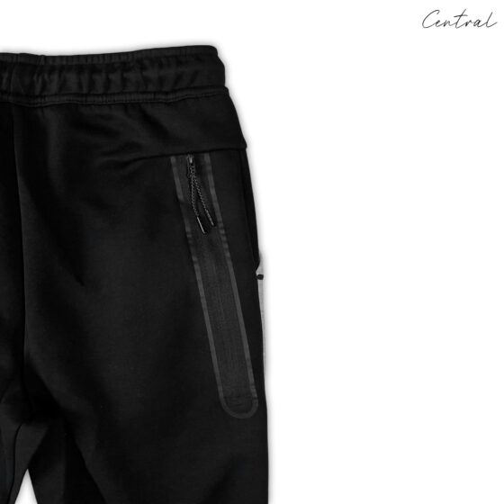 Grey and black Nike Tech Fleece tracksuit featuring a hoodie and pants set displayed on a neutral background.