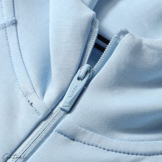 Central ae NOCTA Tech Fleece hoodie and pants set in a sleek design, showcasing fabric texture and comfortable fit.