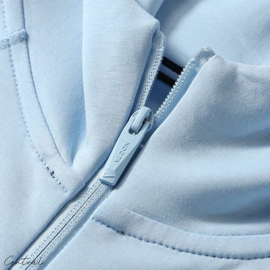 Central ae NOCTA Tech Fleece hoodie and pants set in a sleek design, showcasing fabric texture and comfortable fit.