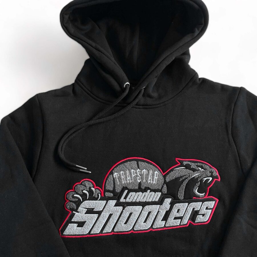 Trapstar Shooters black-red tracksuit featuring a stylish hoodie and matching pants set.