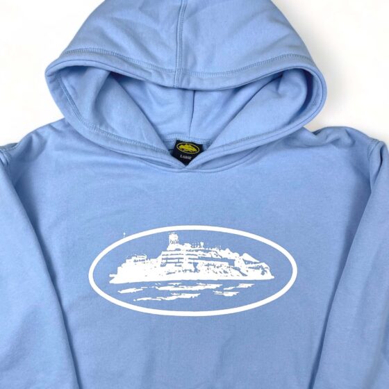 Corteiz Alcatraz hoodie in baby blue featuring a relaxed fit and logo design, perfect for casual wear.