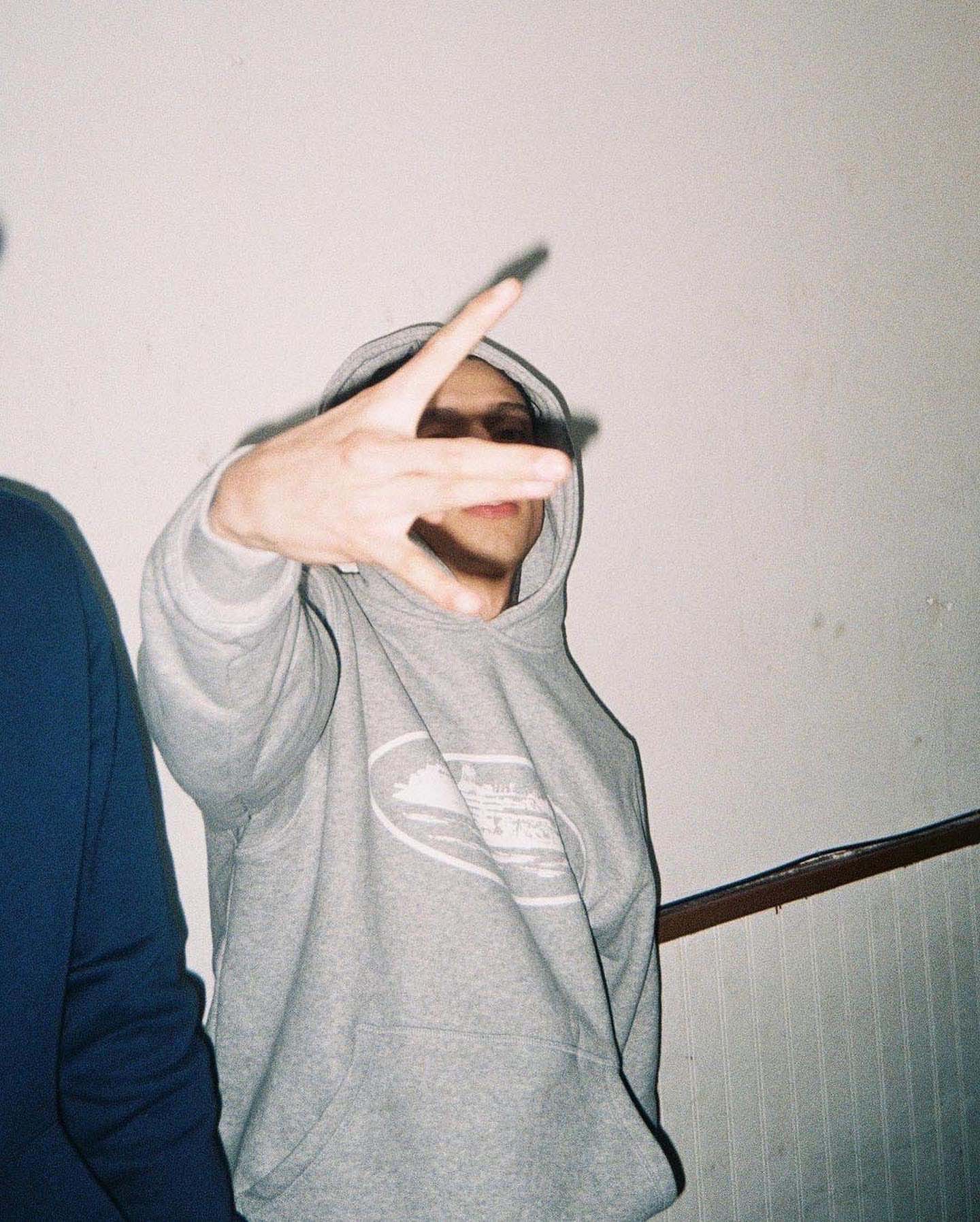Grey Corteiz Alcatraz hoodie featuring a front pocket and drawstring hood, displayed on a neutral background.
