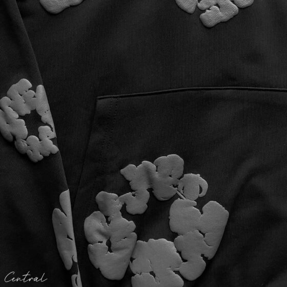 Black monochrome hoodie with cotton wreath design by Central ae, featuring a relaxed fit and soft fabric texture.