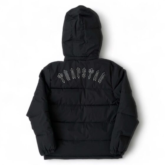 Trapstar Irongate black detachable hooded puffer jacket displayed with a sleek design and modern silhouette.