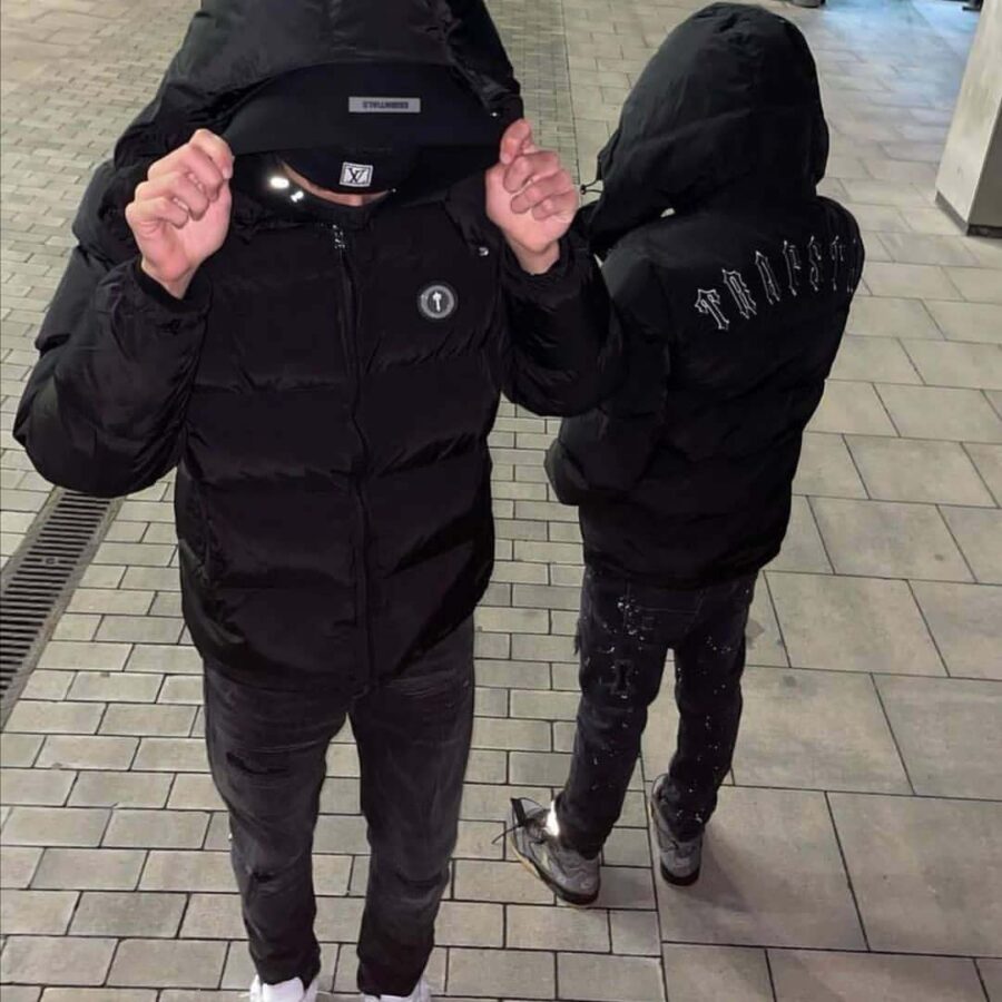 Trapstar Irongate black detachable hooded puffer jacket, featuring a sleek design and cozy padding for warmth.