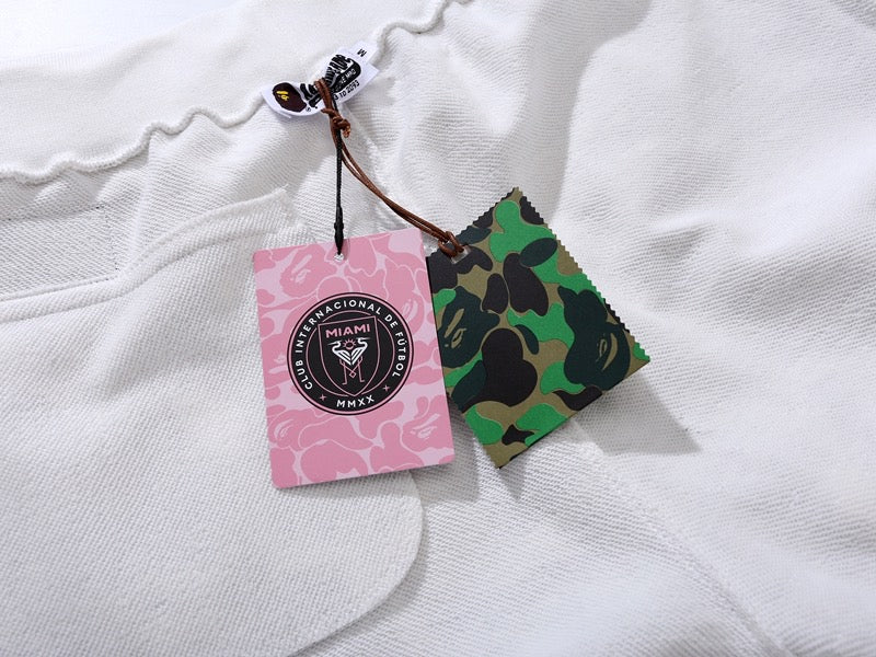BAPE x Inter Miami white camo shorts featuring a unique pattern and comfortable fit by Central ae.