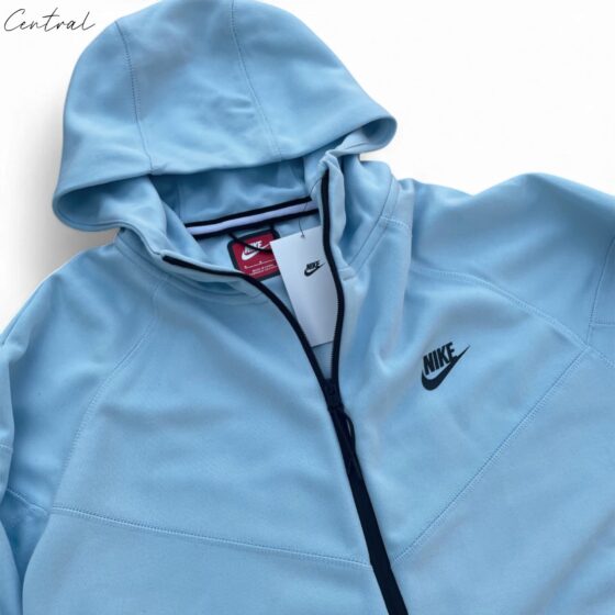 Baby blue Nike Tech Fleece tracksuit featuring a zip-up jacket and matching pants for infants.