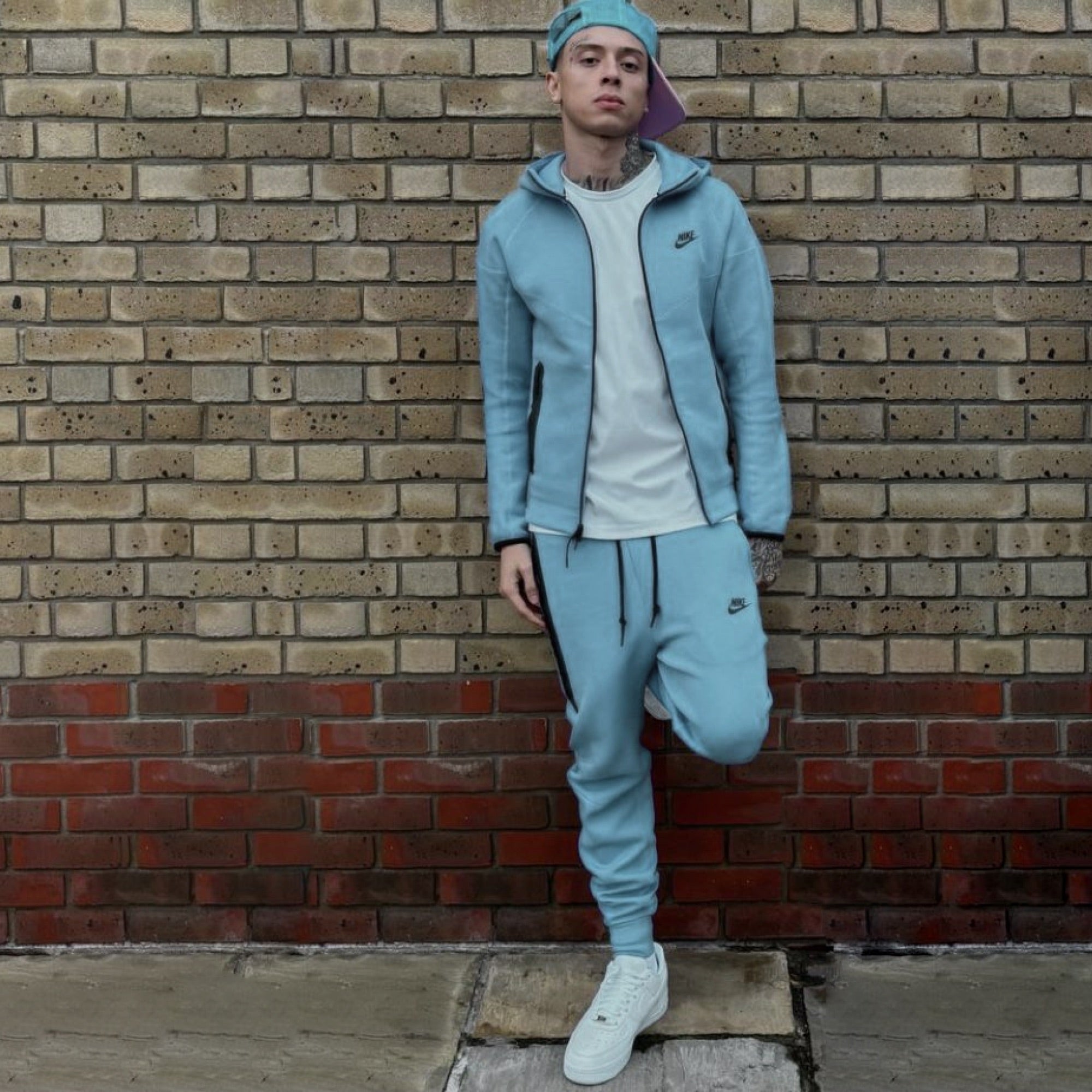 Baby blue Nike Tech Fleece tracksuit featuring a zip-up jacket and matching pants for toddlers.