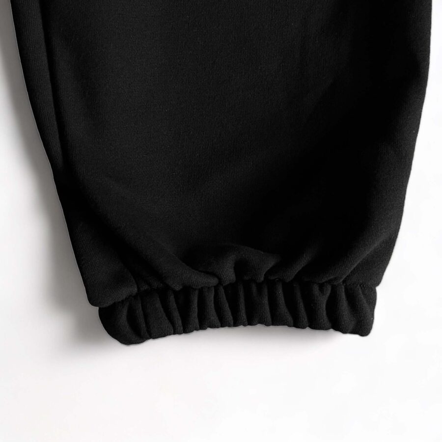 Black Corteiz Alcatraz sweatpants featuring a relaxed fit and elastic waistband, perfect for casual wear.