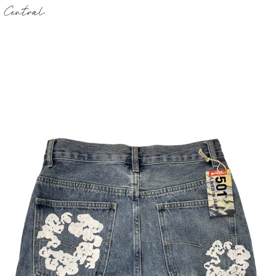 Light wash denim jeans from Denim Tears by Levi's, featuring a unique cotton wreath design and classic fit.