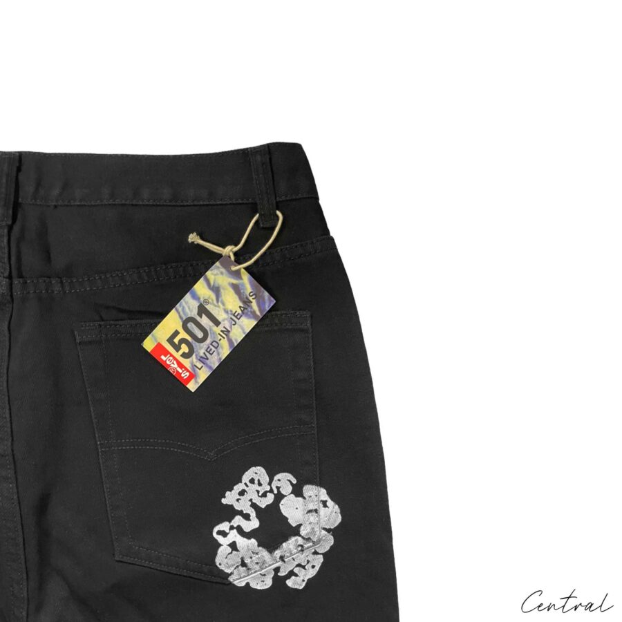 Denim Tears Levi's Cotton Wreath Jeans displayed on a white background, showcasing the unique floral design and denim texture.