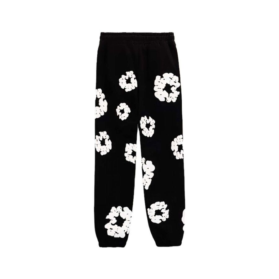 Black sweatpants featuring a cotton wreath design by Denim Tears, showcasing a relaxed fit and soft fabric.